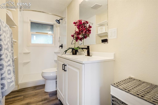 3905 Allgood Dr, Colorado Springs, CO 80911 - bathroom with vanity, wood finished floors, toilet, and curtained shower