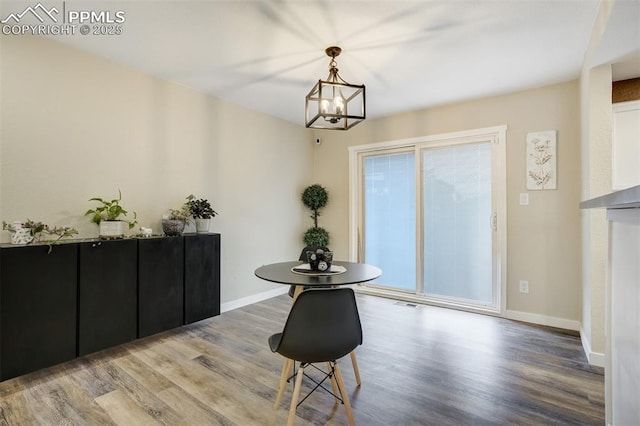 3905 Allgood Dr, Colorado Springs, CO 80911 - dining room featuring wood finished floors, a chandelier, and baseboards