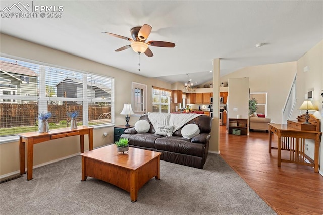4298 Apache Plume Dr, Colorado Springs, CO 80920 - carpeted living room with ceiling fan, a chandelier, lofted ceiling, baseboards, and wood finished floors