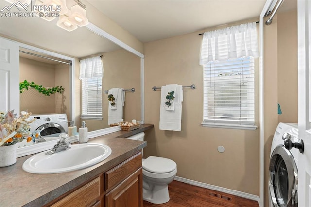 4298 Apache Plume Dr, Colorado Springs, CO 80920 - bathroom featuring washer / dryer, wood finished floors, and healthy amount of natural light