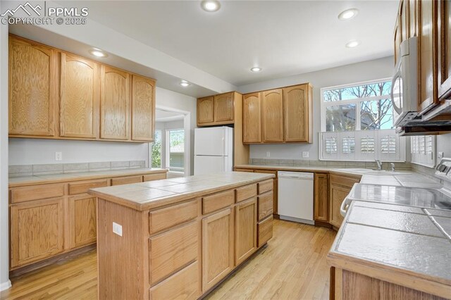 1264 Castle Hills Pl, Colorado Springs, CO 80921 - kitchen with white appliances, tile countertops, plenty of natural light, light wood finished floors, and recessed lighting