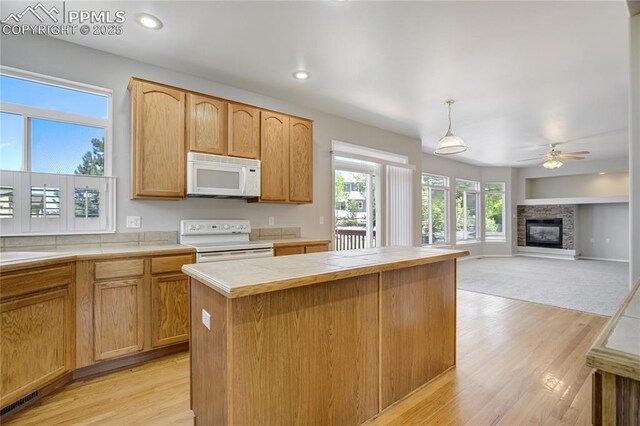 1264 Castle Hills Pl, Colorado Springs, CO 80921 - kitchen featuring white appliances, tile countertops, light wood-style flooring, ceiling fan, and recessed lighting