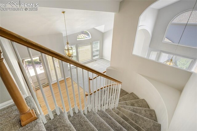 1264 Castle Hills Pl, Colorado Springs, CO 80921 - staircase featuring high vaulted ceiling, healthy amount of natural light, baseboards, and a chandelier