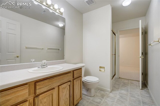 1264 Castle Hills Pl, Colorado Springs, CO 80921 - full bath featuring toilet, vanity, a shower stall, and baseboards