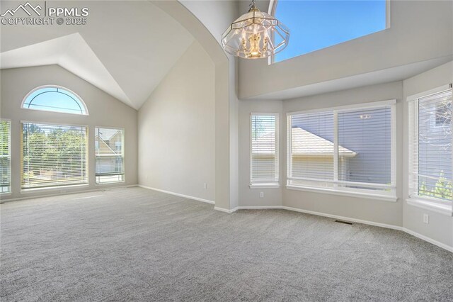 1264 Castle Hills Pl, Colorado Springs, CO 80921 - carpeted spare room featuring a chandelier, arched walkways, baseboards, and high vaulted ceiling