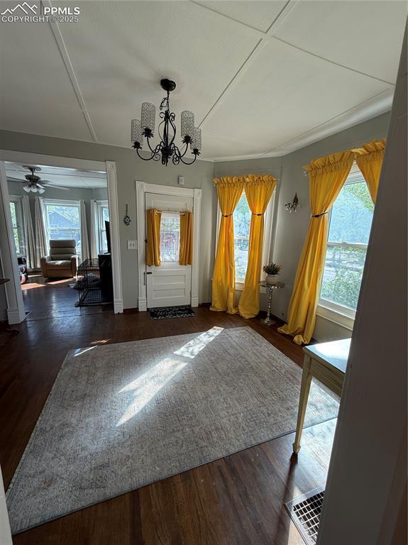 2932 W Kiowa St, Colorado Springs, CO 80904 - doorway featuring a chandelier, wood finished floors, and plenty of natural light