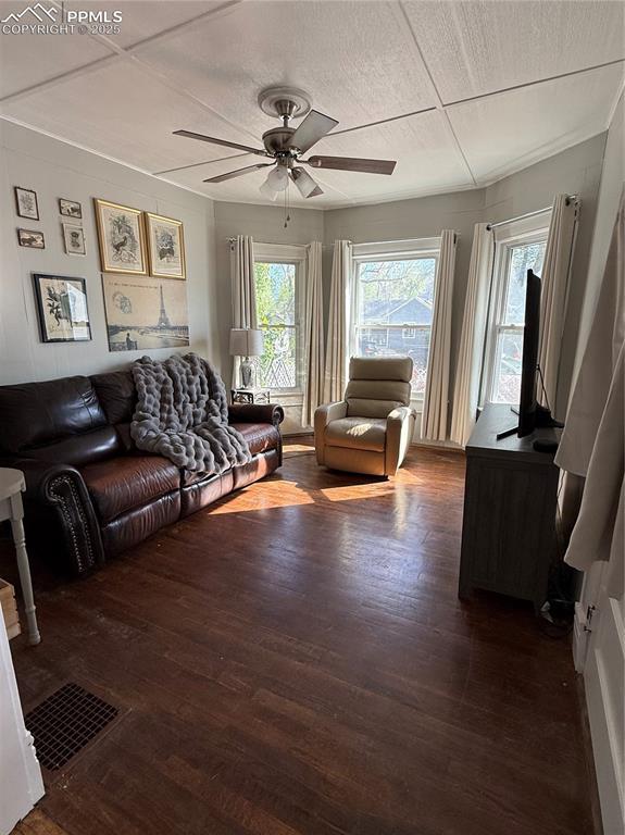 2932 W Kiowa St, Colorado Springs, CO 80904 - living area with a ceiling fan and dark wood-type flooring