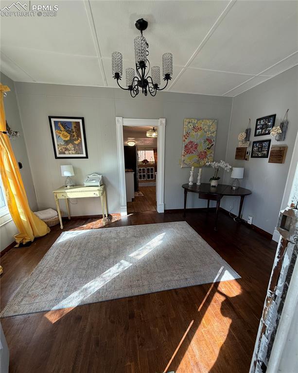 2932 W Kiowa St, Colorado Springs, CO 80904 - dining area with a chandelier, wood finished floors, and baseboards