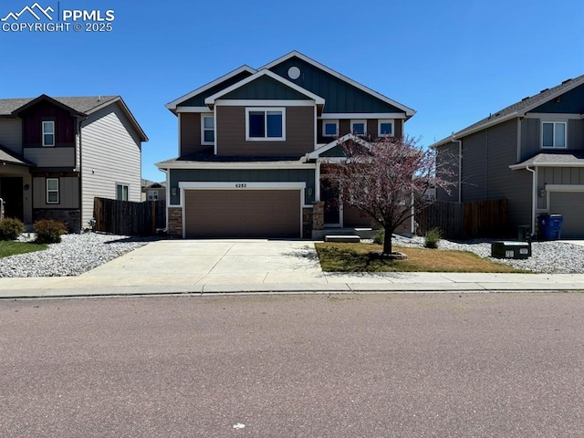 6282 Pilgrimage Rd, Colorado Springs, CO 80925 - craftsman inspired home featuring board and batten siding, fence, stone siding, and driveway