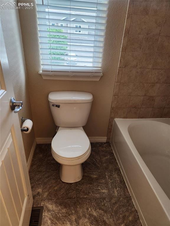 6282 Pilgrimage Rd, Colorado Springs, CO 80925 - bathroom featuring baseboards, a bathtub, toilet, and a shower