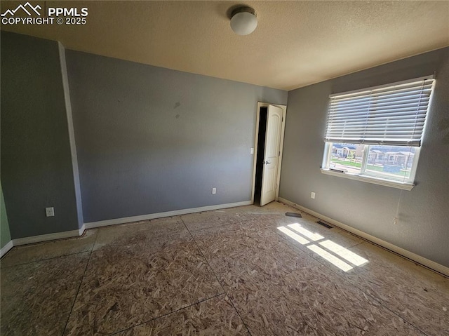 6282 Pilgrimage Rd, Colorado Springs, CO 80925 - empty room with a textured ceiling and baseboards