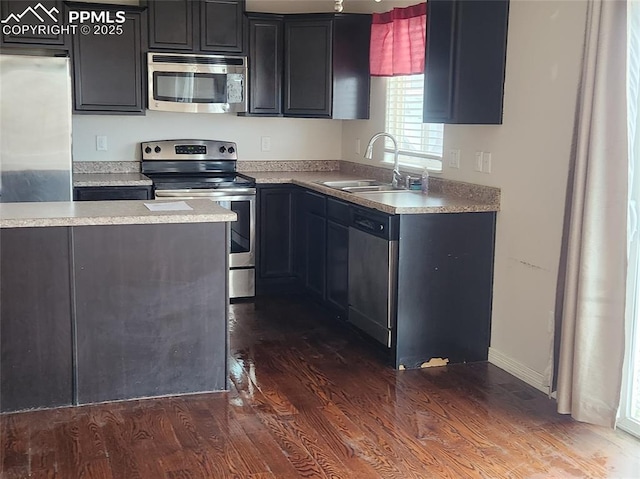 6282 Pilgrimage Rd, Colorado Springs, CO 80925 - kitchen with stainless steel appliances, dark wood-style floors, a sink, and light countertops