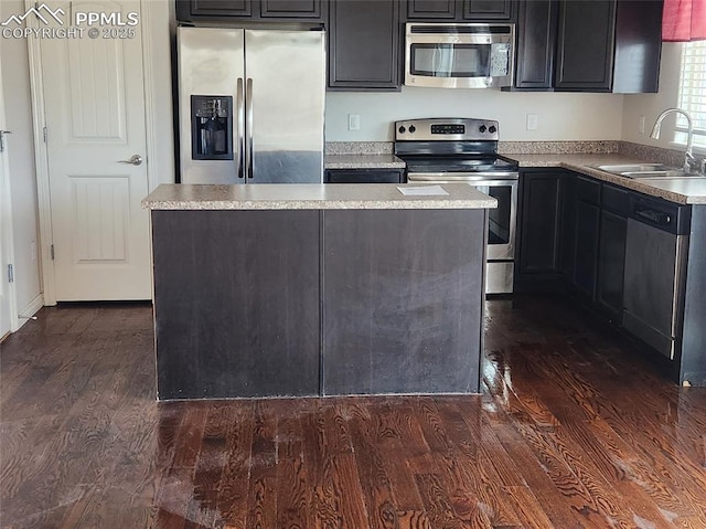 6282 Pilgrimage Rd, Colorado Springs, CO 80925 - kitchen with stainless steel appliances, a sink, dark wood-style floors, a center island, and light countertops