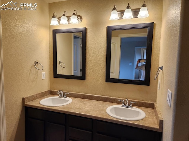 6282 Pilgrimage Rd, Colorado Springs, CO 80925 - full bathroom with a textured wall and double vanity