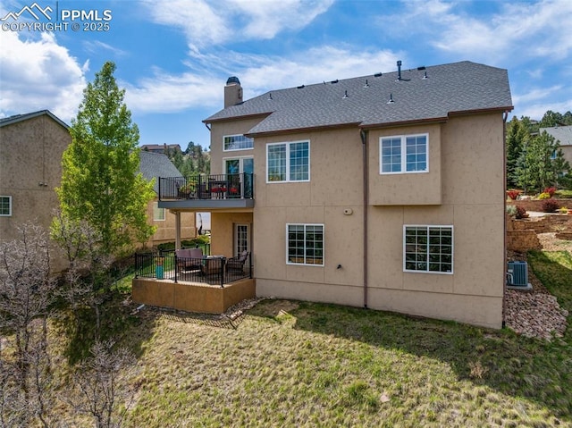 rear view of property featuring a balcony, a chimney, a patio area, central AC, and stucco siding