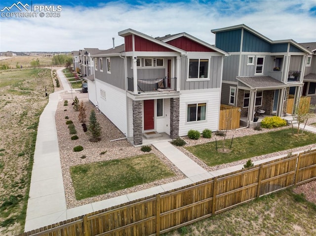 7907 Tremble Pt, Colorado Springs, CO 80908 - view of front of property featuring a balcony, board and batten siding, and stone siding
