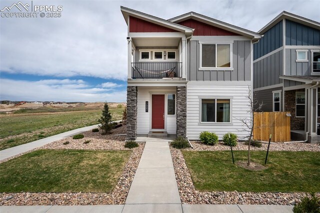 7907 Tremble Pt, Colorado Springs, CO 80908 - view of front of property featuring a balcony, stone siding, and board and batten siding