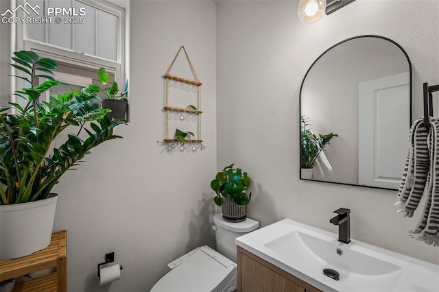 7907 Tremble Pt, Colorado Springs, CO 80908 - bathroom with toilet and vanity
