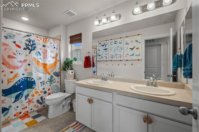7907 Tremble Pt, Colorado Springs, CO 80908 - bathroom featuring double vanity, toilet, tile patterned flooring, and a shower with shower curtain