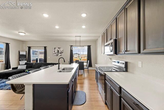 11456 Sanderling St, Colorado Springs, CO 80925 - kitchen featuring a sink, appliances with stainless steel finishes, light wood-style flooring, light countertops, and recessed lighting