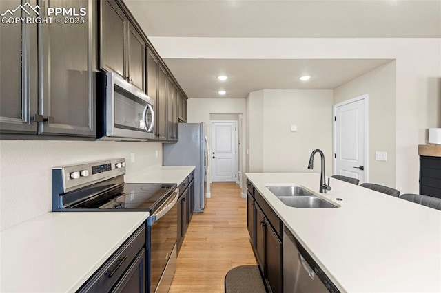 11456 Sanderling St, Colorado Springs, CO 80925 - kitchen with appliances with stainless steel finishes, a sink, light wood-type flooring, recessed lighting, and light countertops