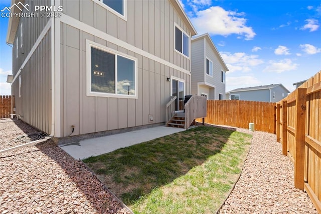 11456 Sanderling St, Colorado Springs, CO 80925 - back of house with board and batten siding, a fenced backyard, and a patio