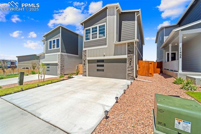 11456 Sanderling St, Colorado Springs, CO 80925 - contemporary home featuring stone siding, an attached garage, concrete driveway, and board and batten siding