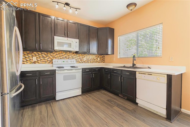 3808 Happy Jack Dr, Colorado Springs, CO 80922 - kitchen with white appliances, a sink, wood finished floors, and light countertops