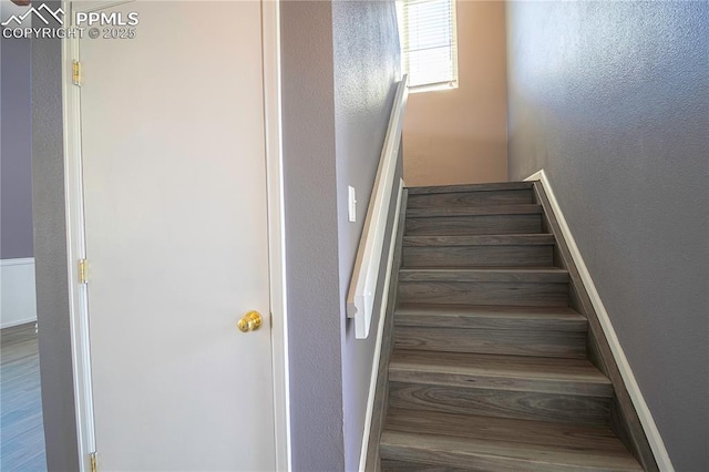3808 Happy Jack Dr, Colorado Springs, CO 80922 - stairs featuring a textured wall and wood finished floors