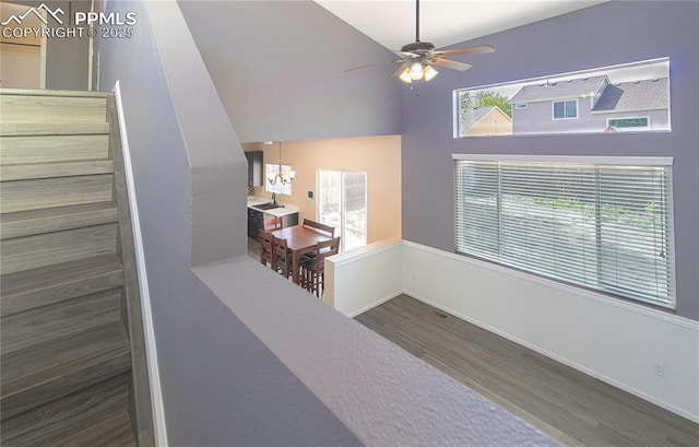 3808 Happy Jack Dr, Colorado Springs, CO 80922 - stairs with wood finished floors, a chandelier, a ceiling fan, baseboards, and high vaulted ceiling