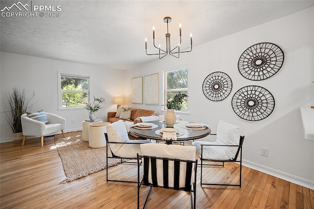 1428 N Prospect St, Colorado Springs, CO 80907 - dining area with healthy amount of natural light, a chandelier, light wood finished floors, and baseboards