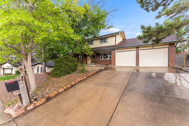 445 Wintery Cir, Colorado Springs, CO 80919 - traditional home featuring brick siding, a garage, and concrete driveway