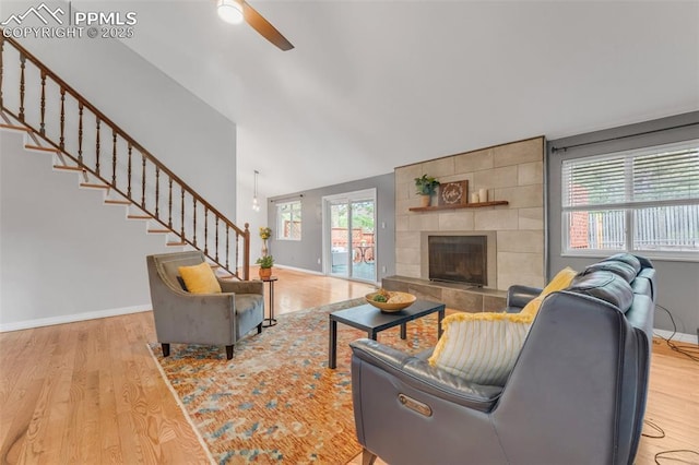 445 Wintery Cir, Colorado Springs, CO 80919 - living room with ceiling fan, light wood finished floors, baseboards, stairs, and vaulted ceiling