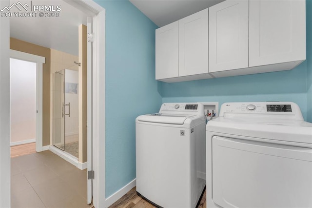 445 Wintery Cir, Colorado Springs, CO 80919 - laundry area featuring independent washer and dryer, cabinet space, and baseboards