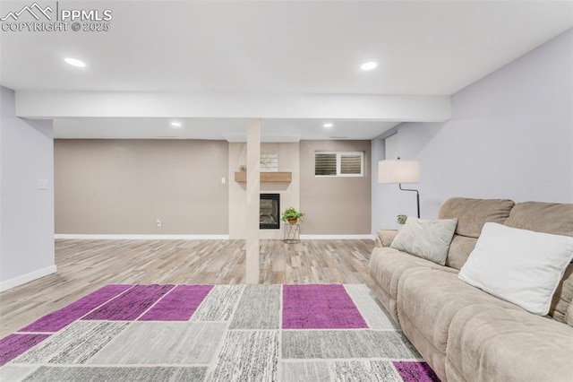445 Wintery Cir, Colorado Springs, CO 80919 - living room with wood finished floors, baseboards, a glass covered fireplace, and recessed lighting