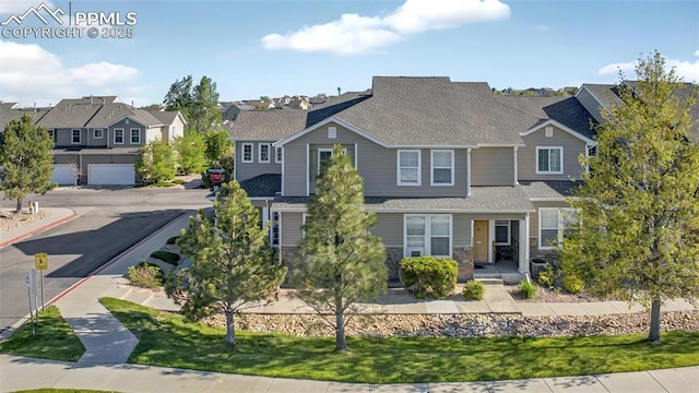 7470 Sandy Springs Pt, Fountain, CO 80817 - view of front of house with a residential view, stone siding, and roof with shingles