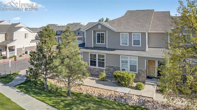 7470 Sandy Springs Pt, Fountain, CO 80817 - view of front facade featuring a residential view, stone siding, and roof with shingles