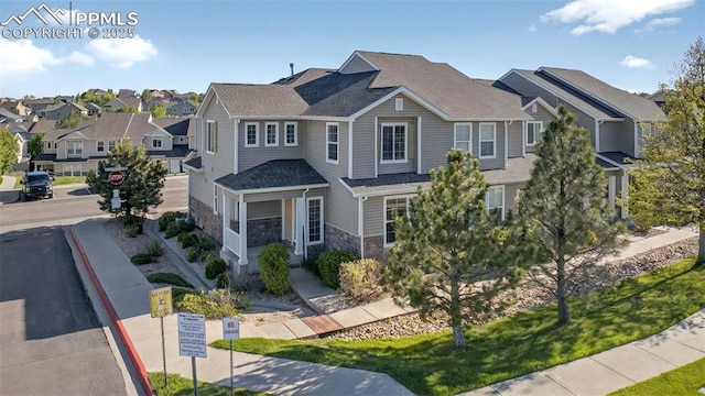 7470 Sandy Springs Pt, Fountain, CO 80817 - view of front facade with stone siding, a residential view, and roof with shingles