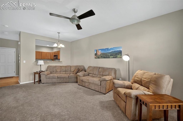 7470 Sandy Springs Pt, Fountain, CO 80817 - living room featuring a ceiling fan, light colored carpet, a chandelier, and baseboards