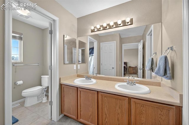 7470 Sandy Springs Pt, Fountain, CO 80817 - bathroom with toilet, tile patterned floors, double vanity, and baseboards