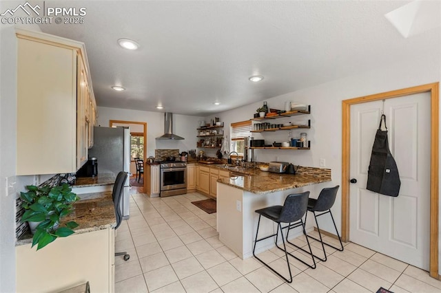 921 Cottonwood Lake Dr, Divide, CO 80814 - kitchen with wall chimney range hood, stainless steel appliances, open shelves, a peninsula, and a sink