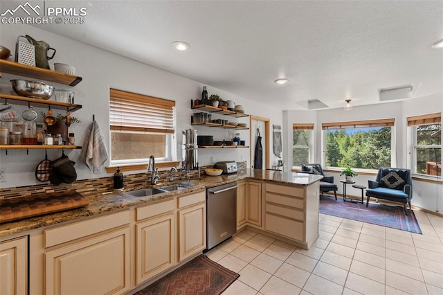 921 Cottonwood Lake Dr, Divide, CO 80814 - kitchen featuring a sink, dishwasher, open shelves, a peninsula, and light tile patterned floors