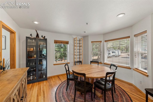 921 Cottonwood Lake Dr, Divide, CO 80814 - dining area with light wood finished floors, recessed lighting, a textured ceiling, and baseboards