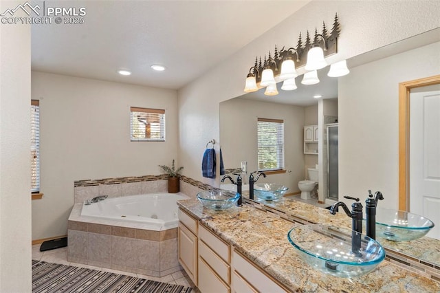921 Cottonwood Lake Dr, Divide, CO 80814 - full bath featuring a jetted tub, a shower stall, tile patterned floors, double vanity, and recessed lighting