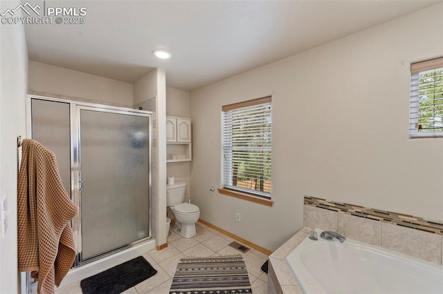 921 Cottonwood Lake Dr, Divide, CO 80814 - bathroom with toilet, a stall shower, tile patterned floors, a bath, and baseboards