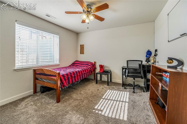 bedroom with carpet flooring, baseboards, ceiling fan, and a textured ceiling