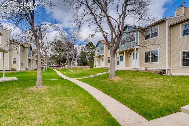 7911 Lexington Park Dr, Colorado Springs, CO 80920 - view of property's community with a lawn and a residential view