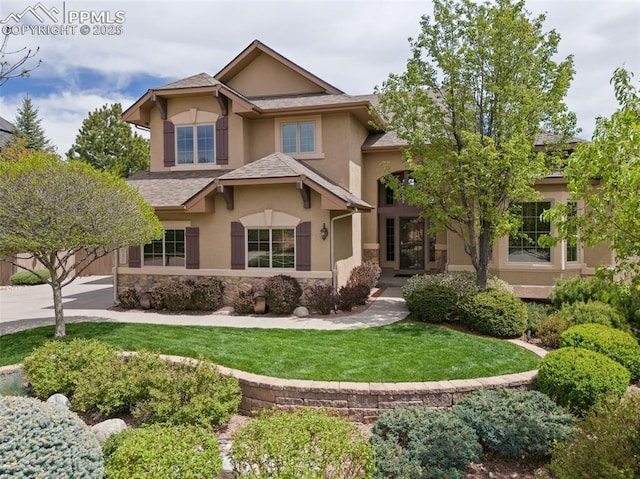 10061 Oak Knoll Ter, Colorado Springs, CO 80920 - view of front of house featuring stucco siding, stone siding, a front lawn, and roof with shingles