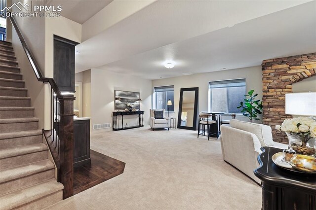 10061 Oak Knoll Ter, Colorado Springs, CO 80920 - living area with light carpet, stairs, and baseboards
