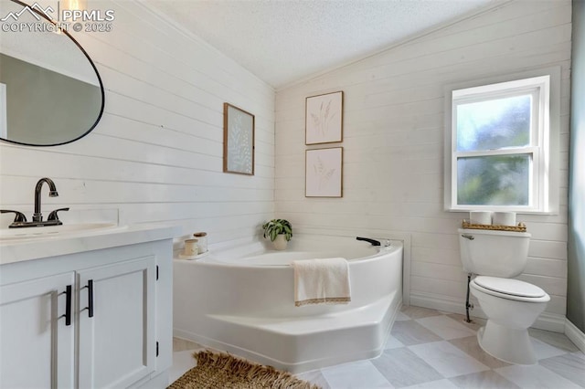 full bath with vanity, a garden tub, wood walls, a textured ceiling, and toilet